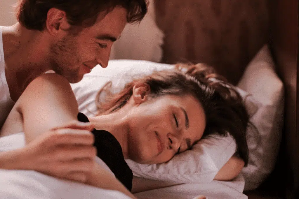 A couple smiling in bed