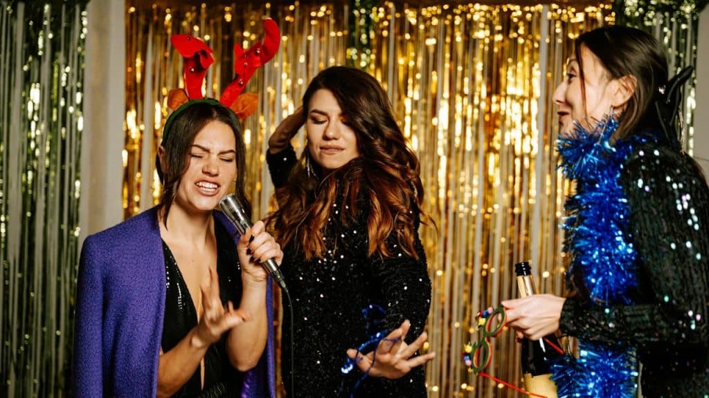 A group of friends singing and dancing at a party.