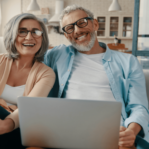 A mature couple smiling at the camera