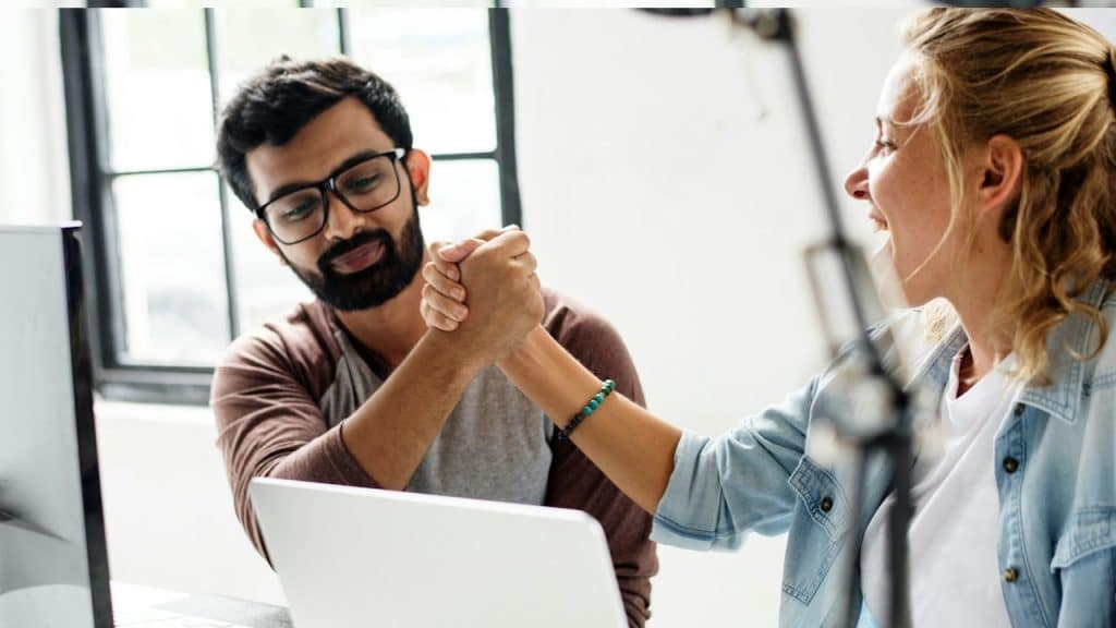 Computer technicians holding hands together.