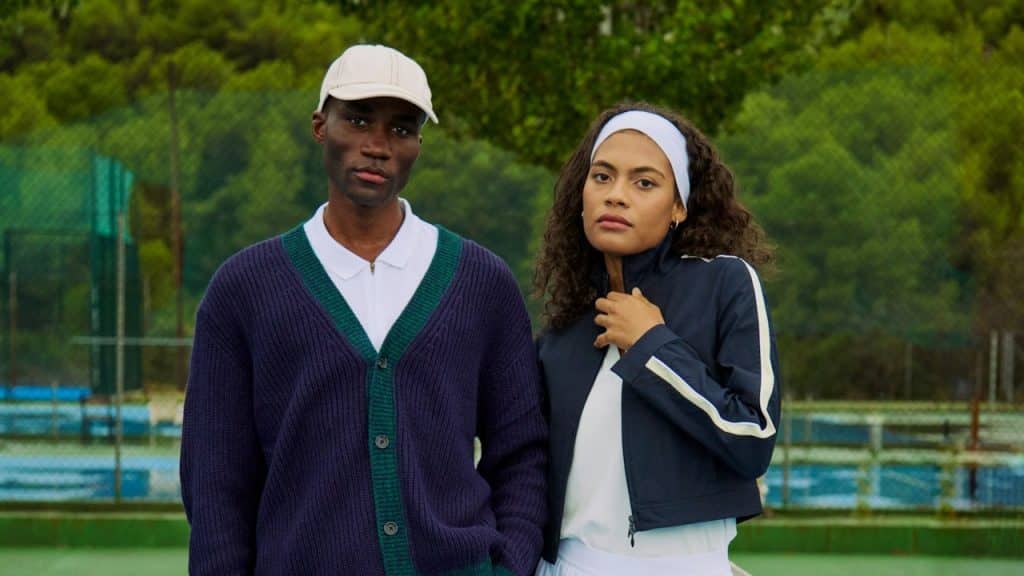 A man and a woman standing on a tennis court.