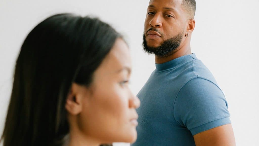 A man looking at his angry wife.