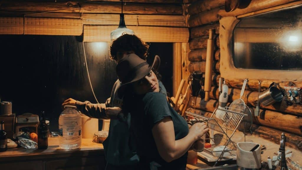 A man and a woman working in a kitchen.