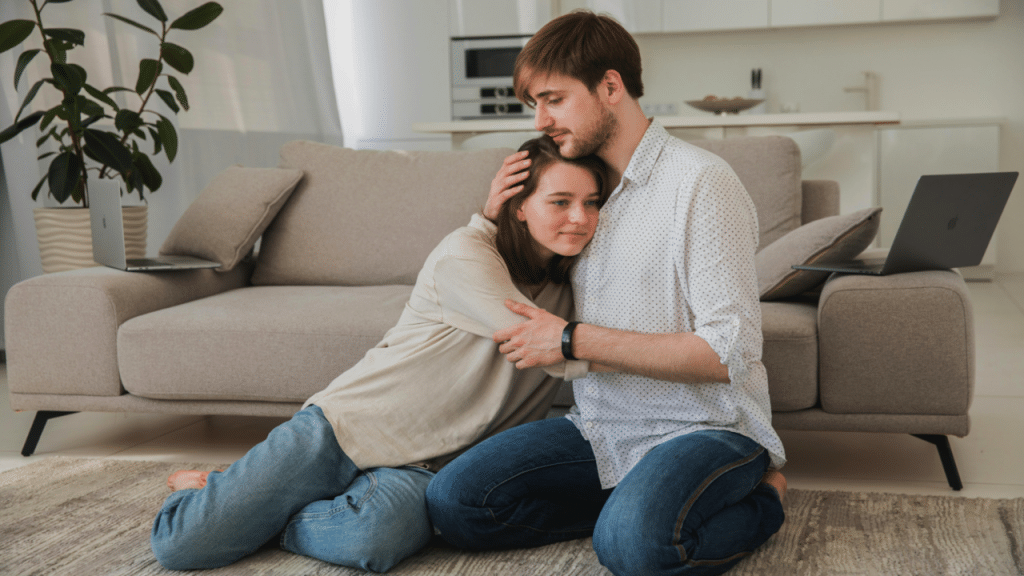 A couple hugging in the living room.