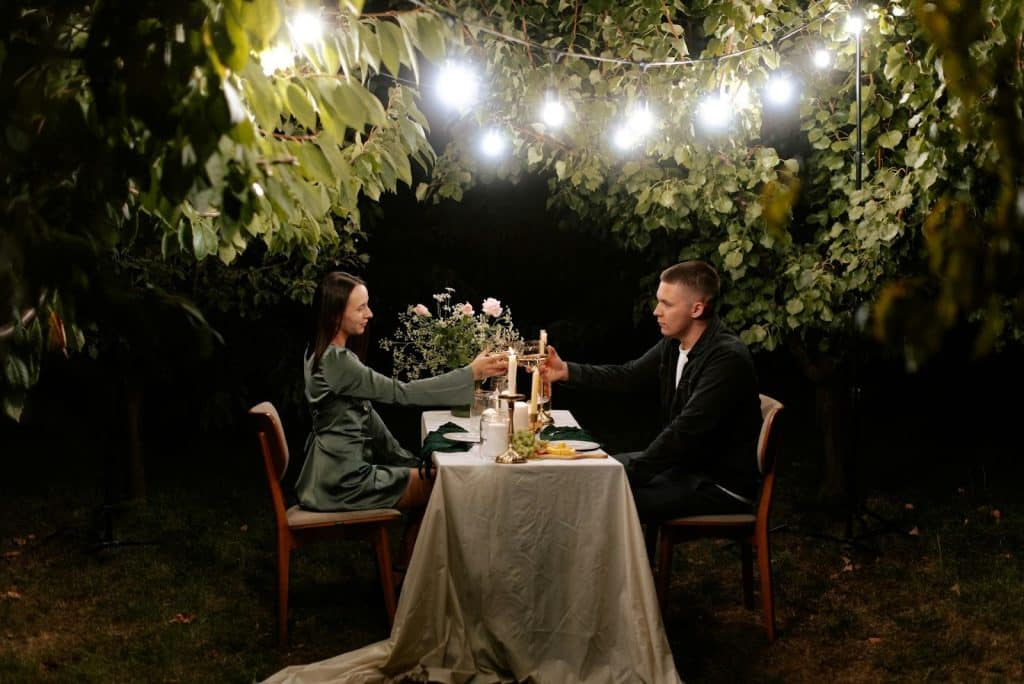 The couple is sitting at a dinner table.