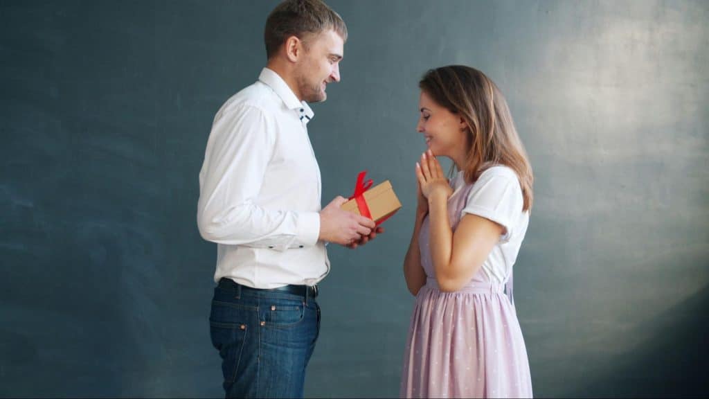 A man giving a gift to woman