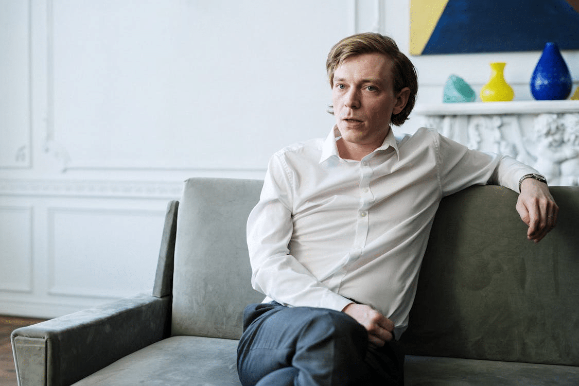 A man sitting on a green couch