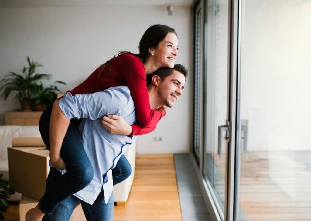 A man carrying a woman on his back