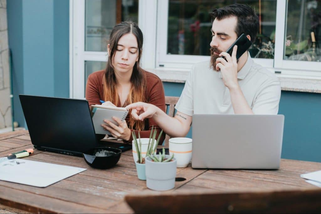 A woman looking dull and a man dictating something to her 