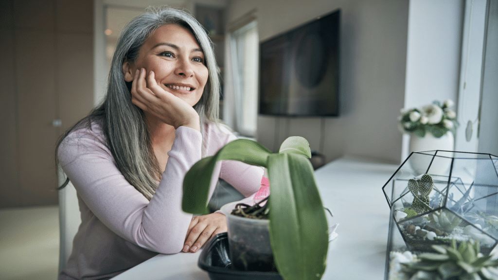 A woman smiling while looking out the window