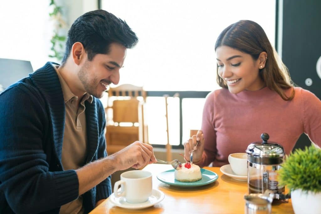 A couple sharing dessert in a café.