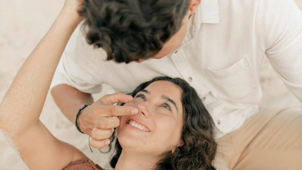 A man gently touches his wife’s face.