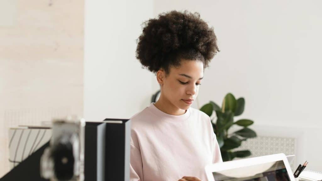 A woman working at a desk with a laptop.