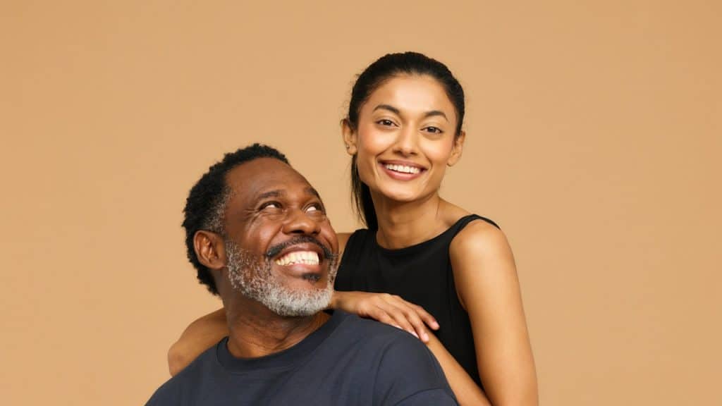 A smiling man and a woman posing for a picture.