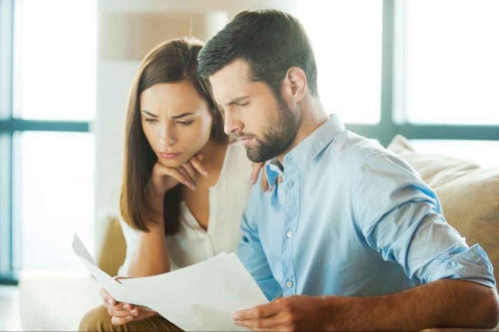 A man and woman looking at the documents