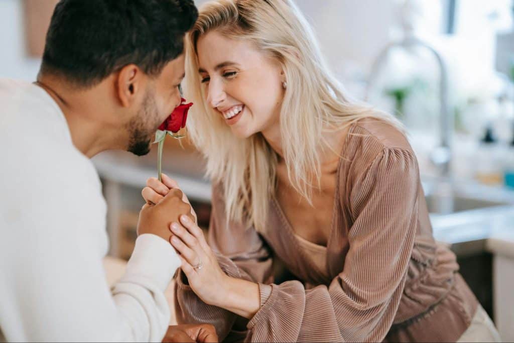 A man giving a rose to a woman