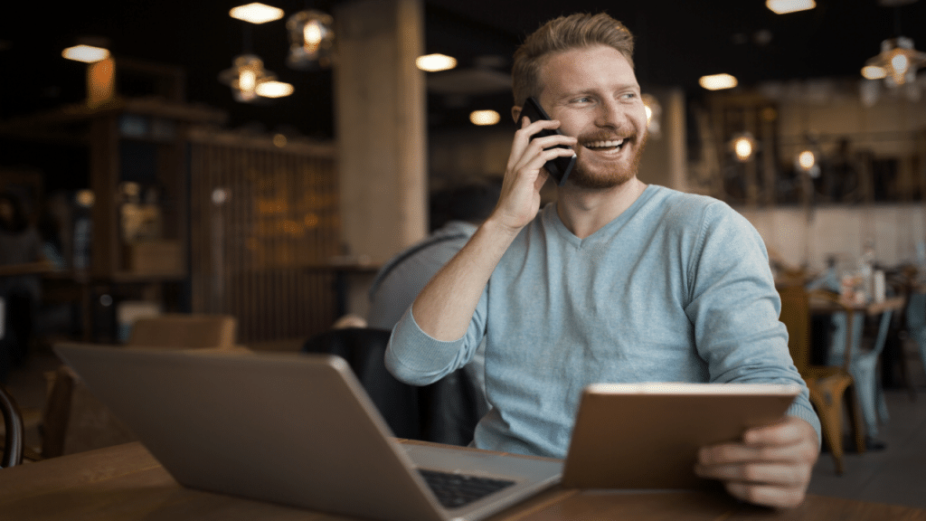 A man laughing while on the phone