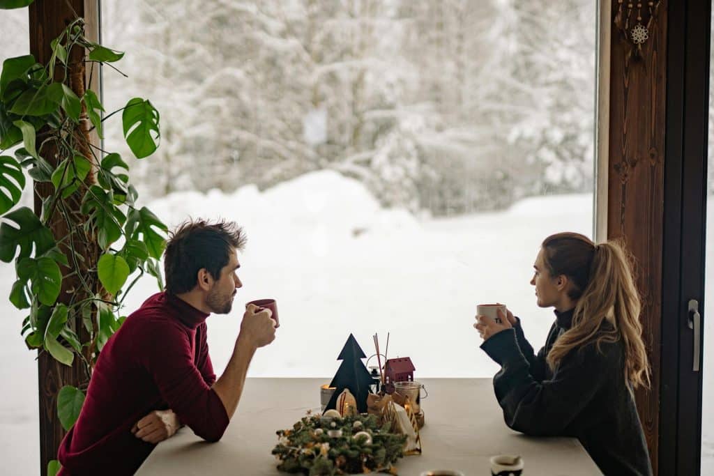 The couple is drinking coffee on a cold winter day.