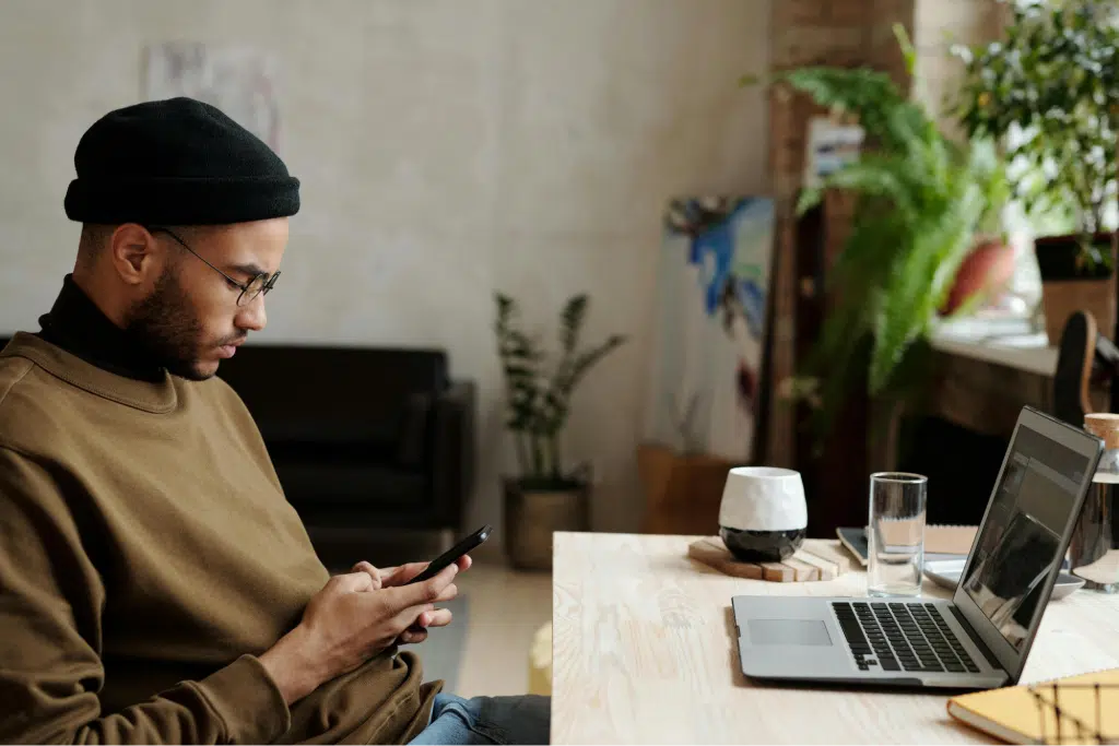 A man in brown texting