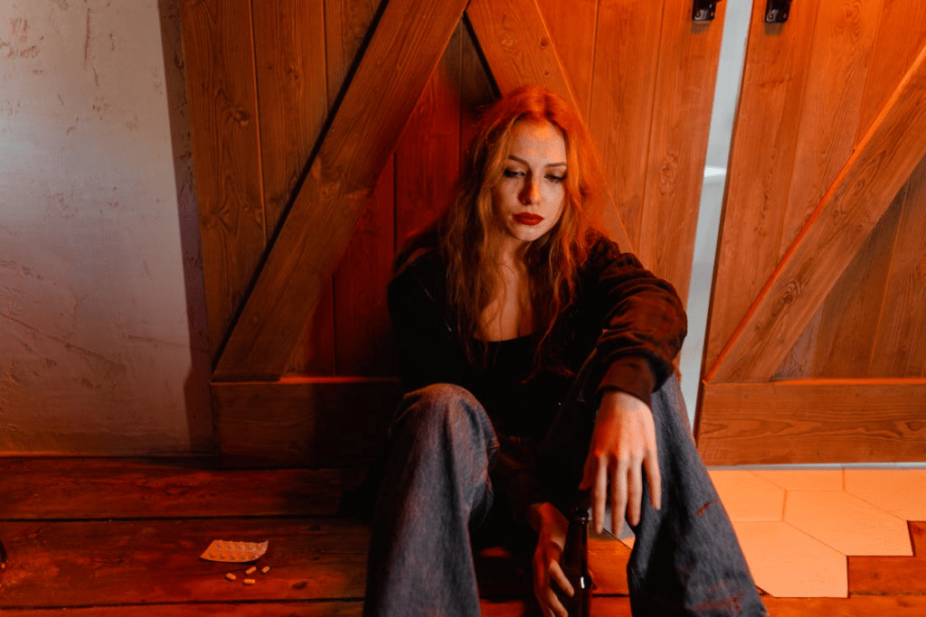 A crying woman sitting on the floor