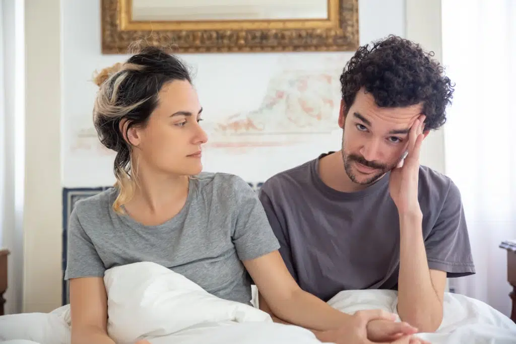 A couple sitting in the bed
