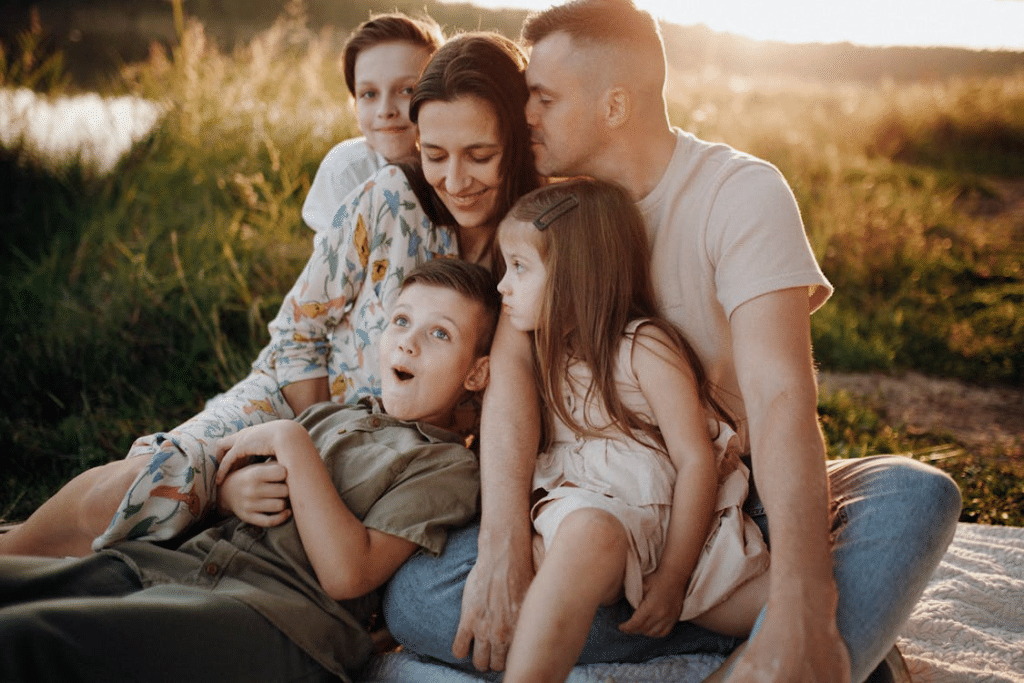 Smiling Family Together on Meadow