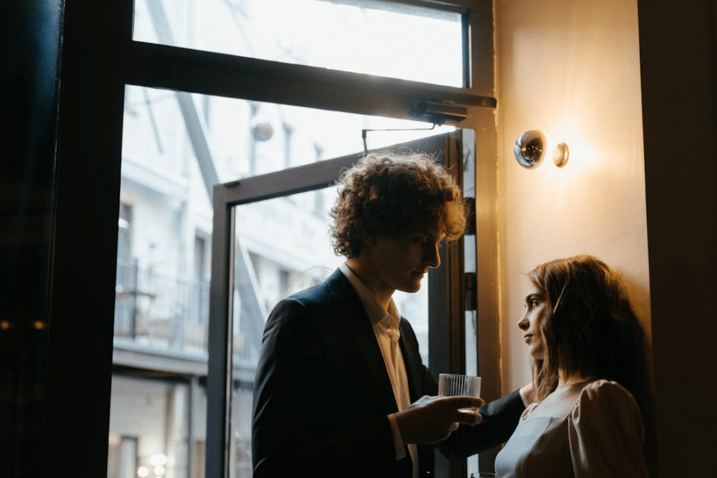 A couple standing near the window
