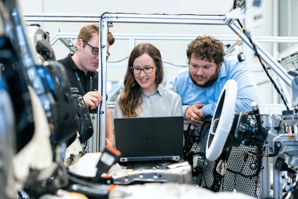Men and a woman in a workshop