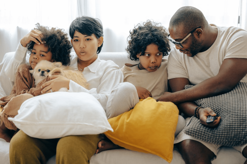 A family sitting on a couch