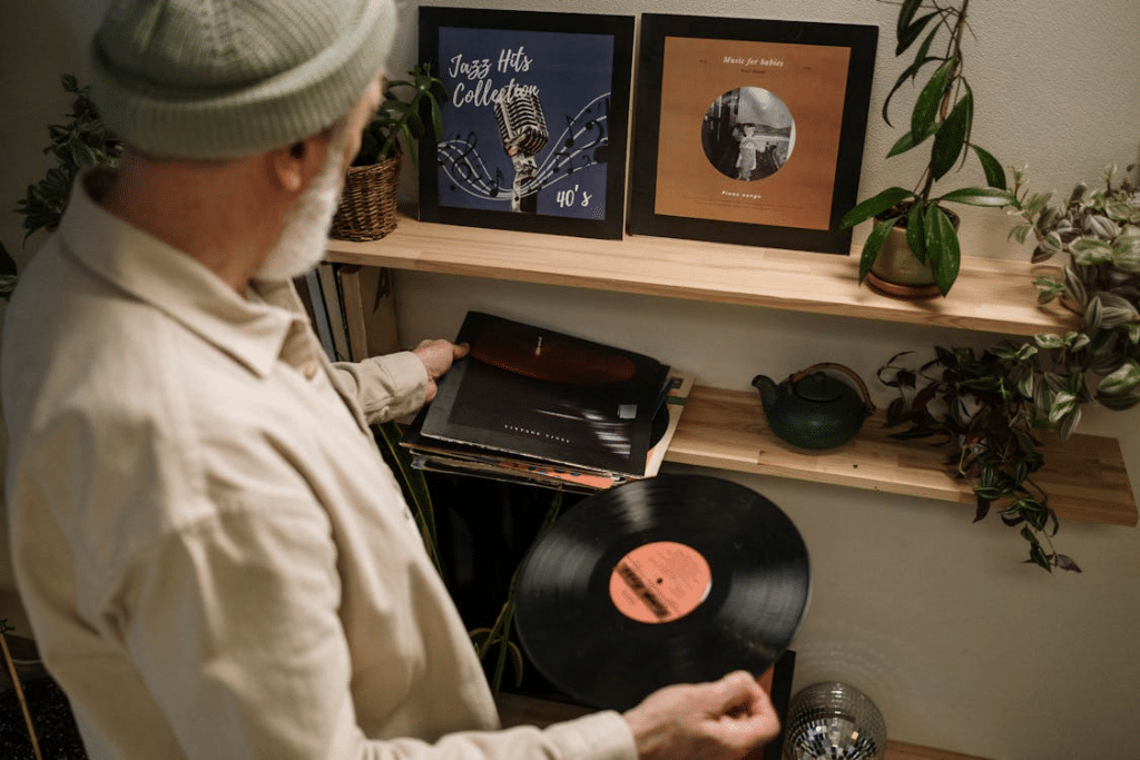 An elderly man holding a phonograph record