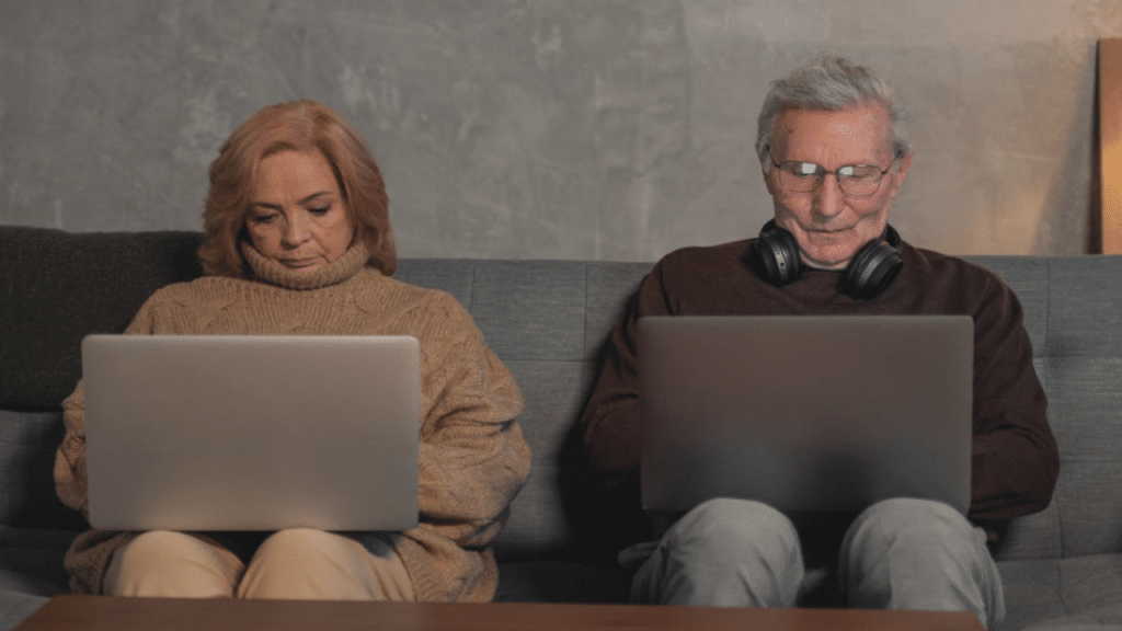 A couple using their laptops at home