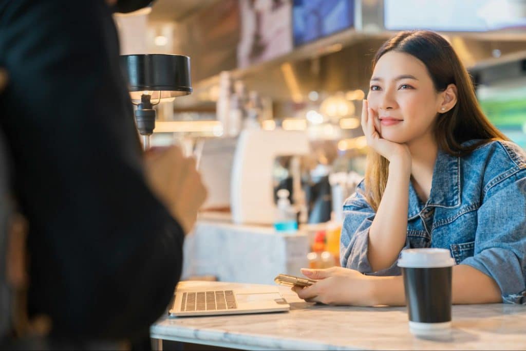 A woman looking at the man