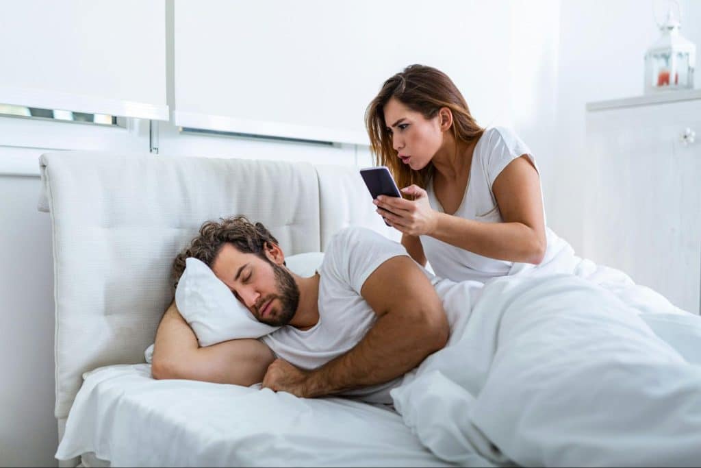 A woman looking at the man’s phone