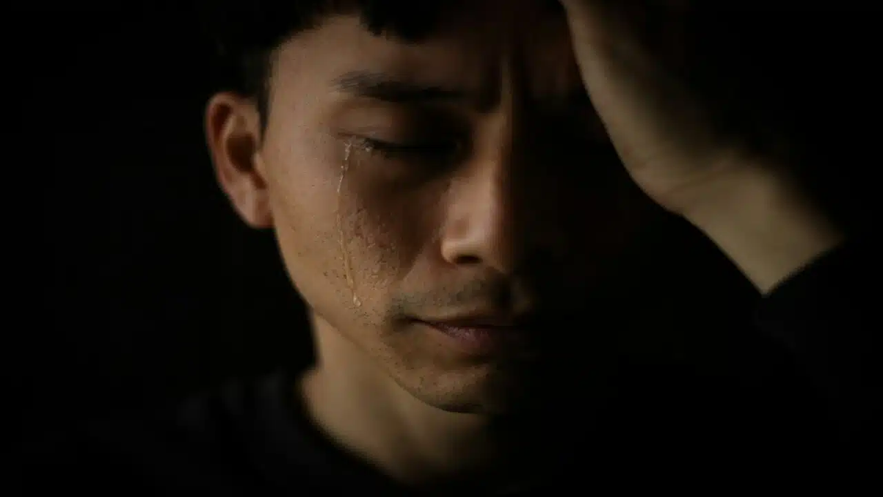 A man crying in the dark
