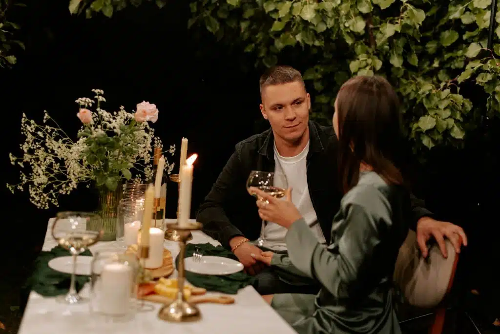 A man and a woman sitting at a dinner table.