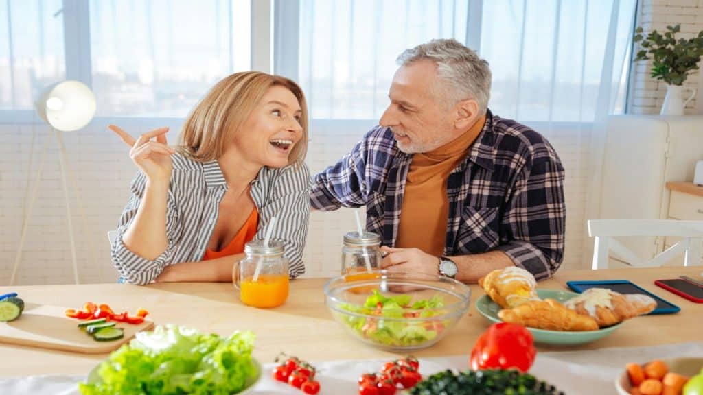 A mature couple having a meal together