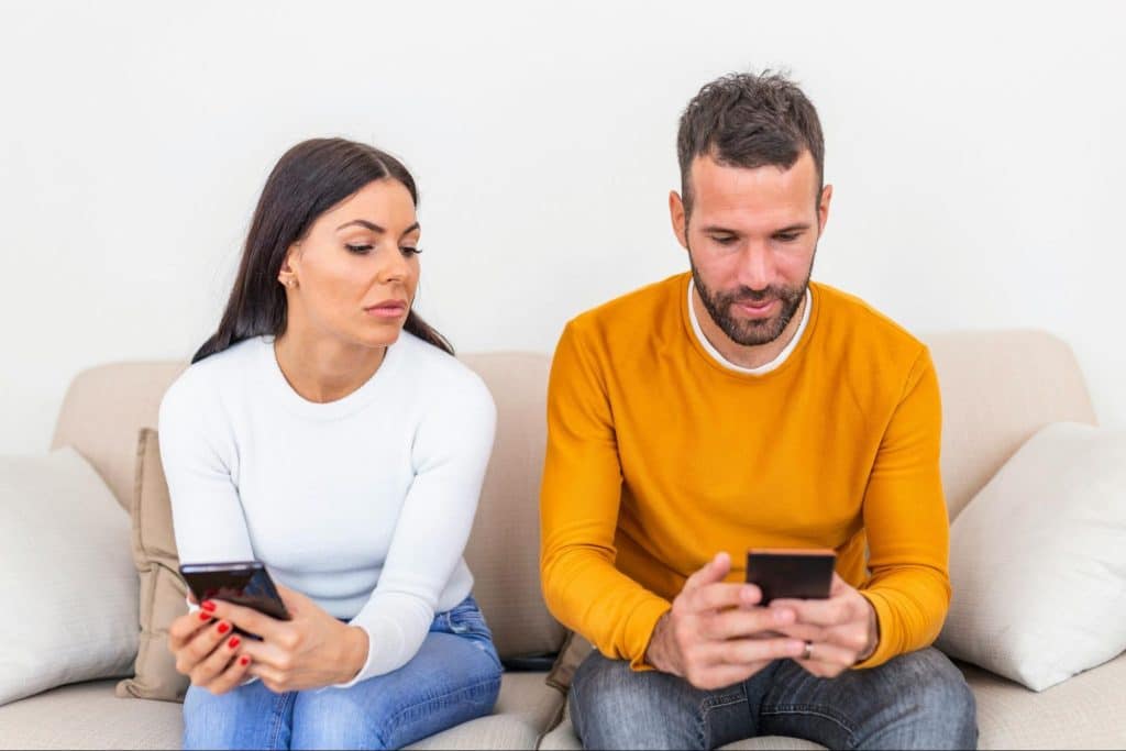 A woman not showing interest on what a man doing