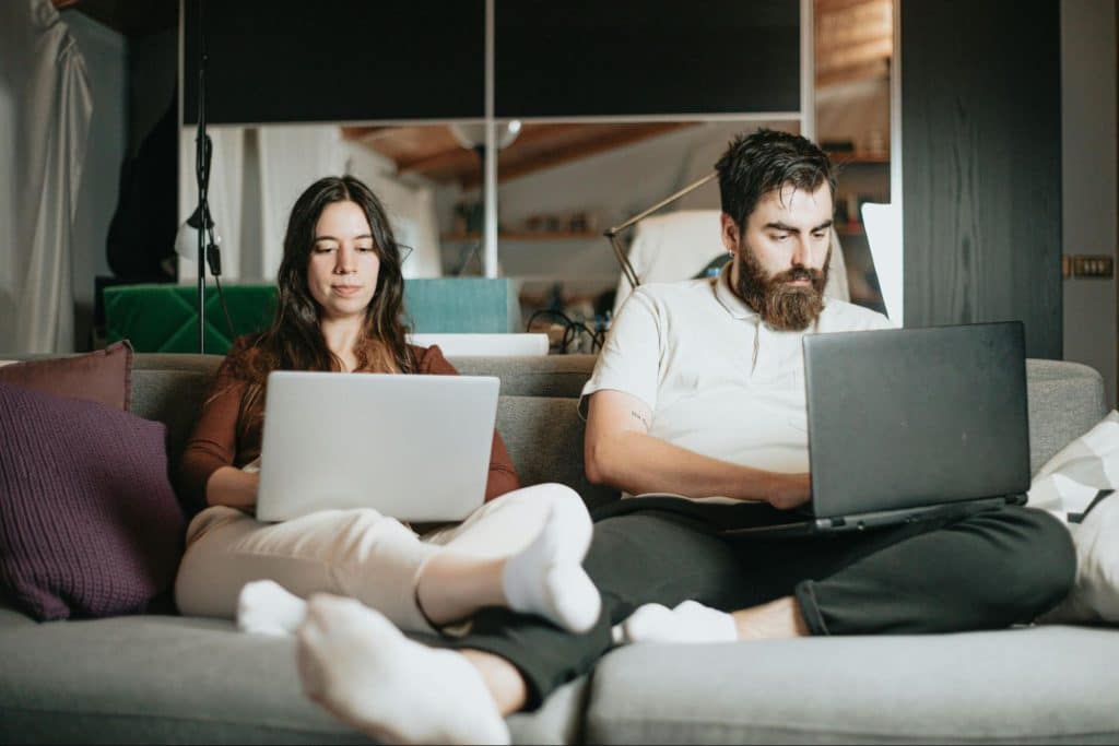 A man and woman busy with their own work