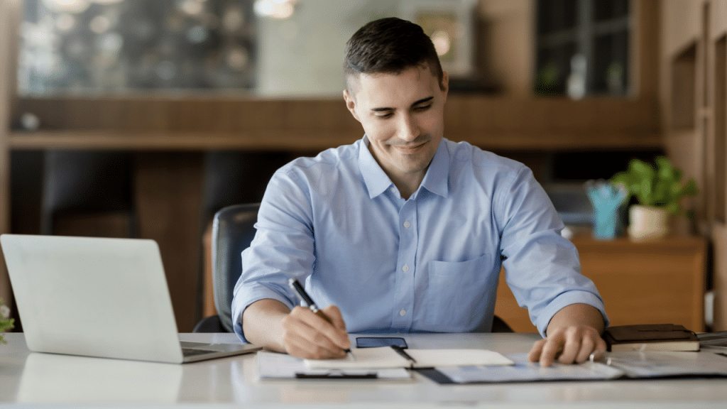 A man taking notes while studying