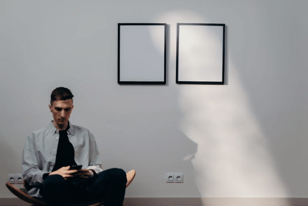 Man in Gray Dress Shirt Sitting on Yellow Chair