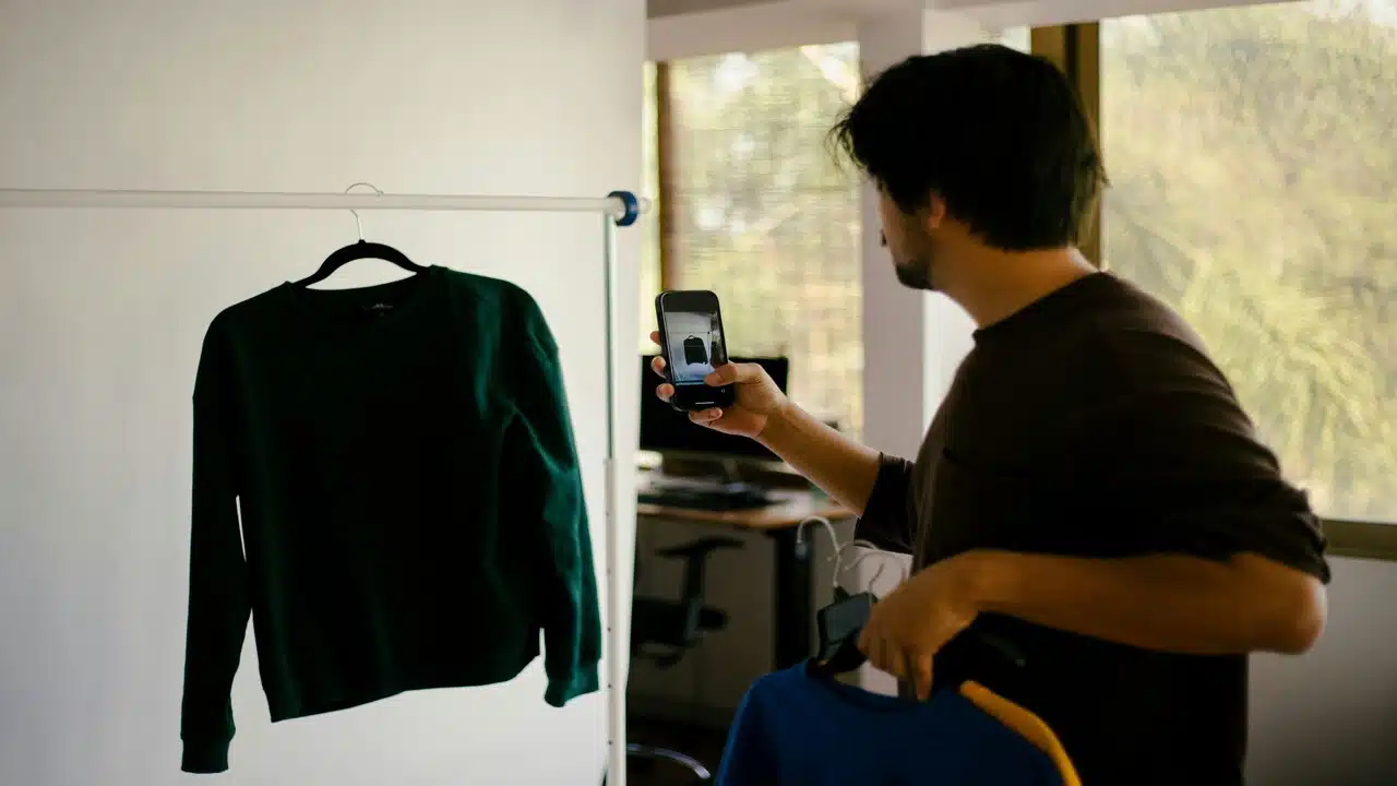 A man taking a photo of his shirt