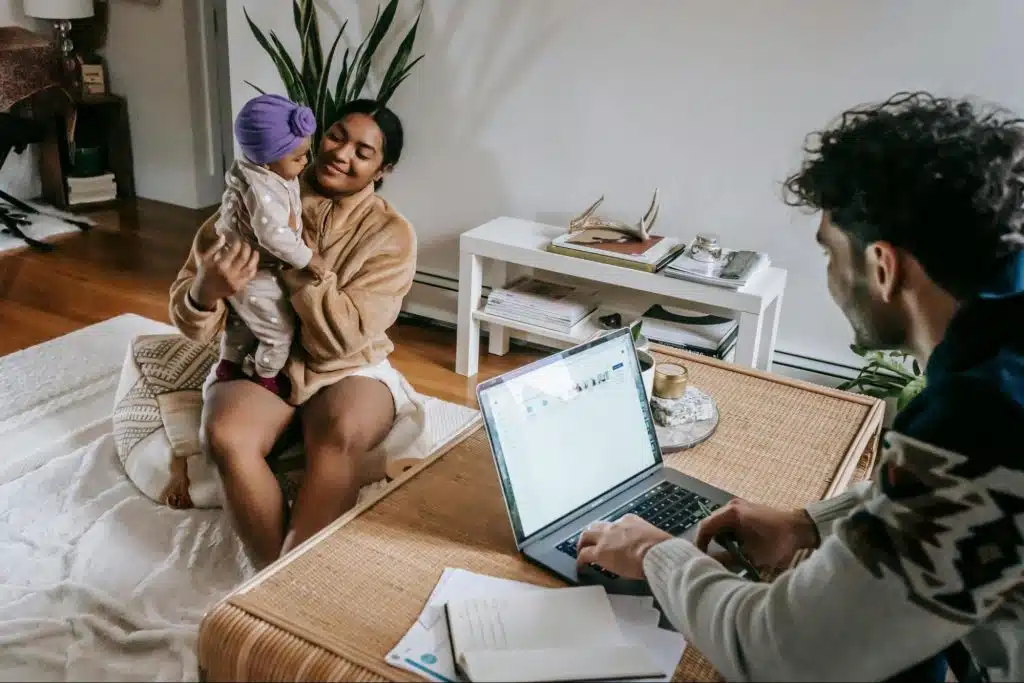 A man working at home and a woman taking care of their child