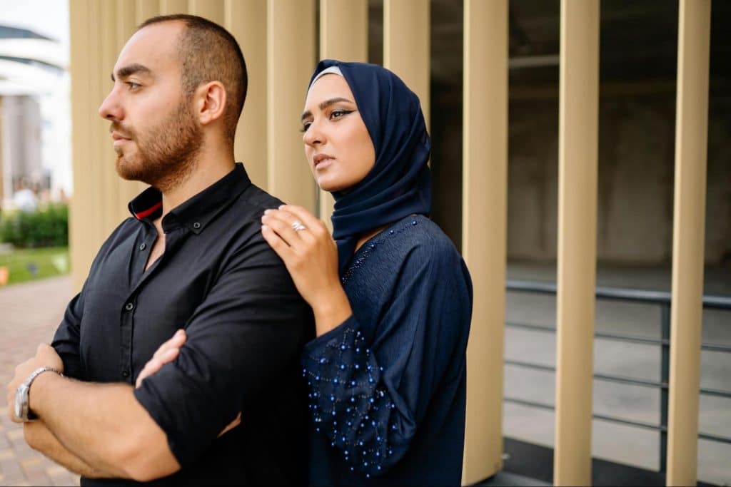 A woman holding a man’s shoulder