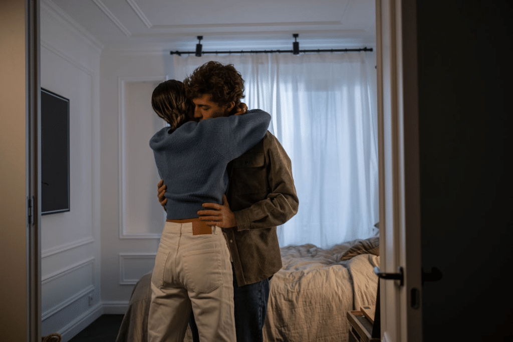 A Couple Hugging Each Other in a Bedroom