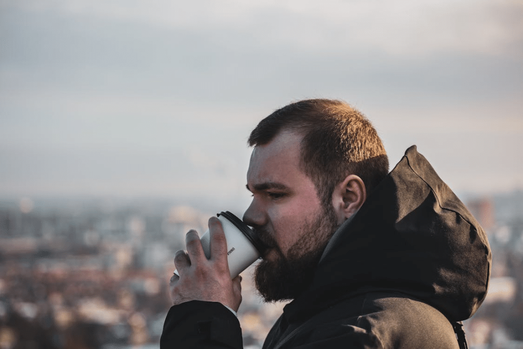Bearded Man Drinking Takeaway Coffee