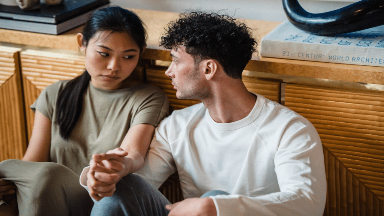 A couple having a serious talk on the floor