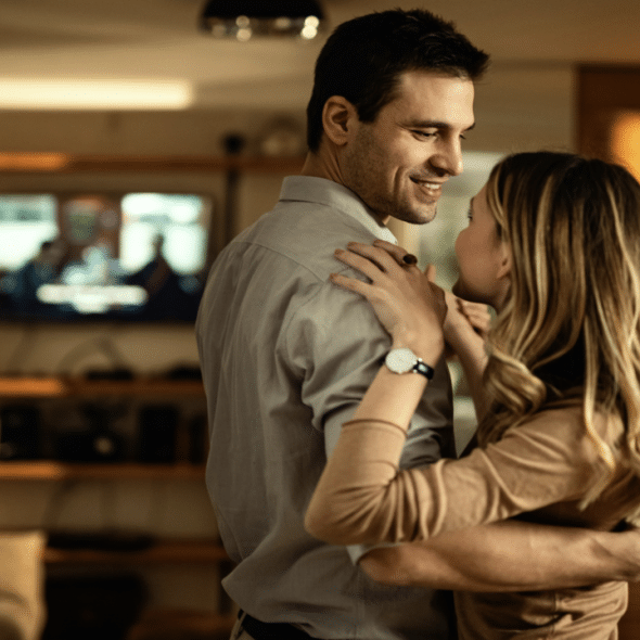 A couple dancing in the living room