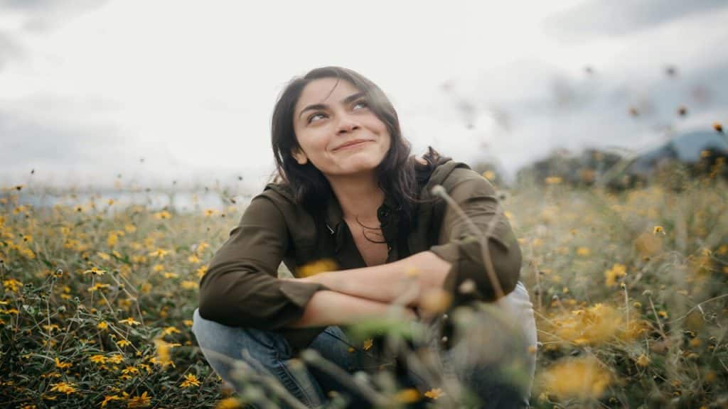 A woman sitting in a field of flowers