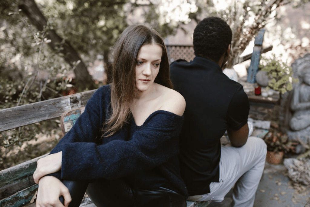 Sad Woman sitting beside Man