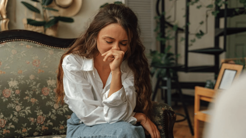 A woman crying on the couch